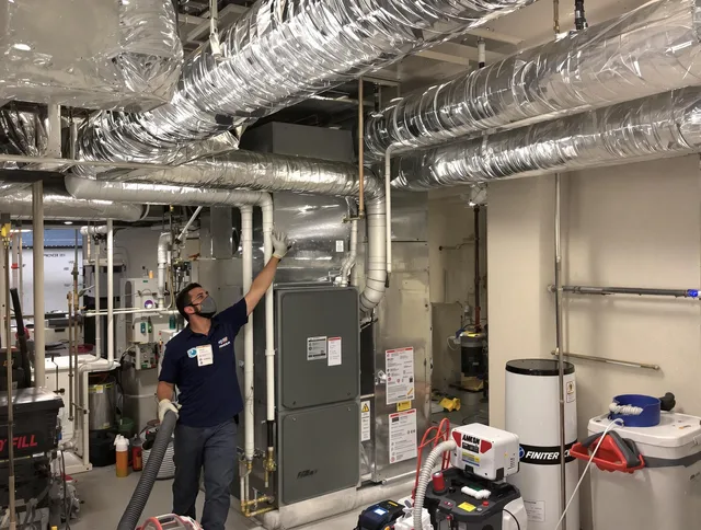 Holbrook Air Duct Cleaning specialist performing thorough furnace duct cleaning in a Holbrook residence