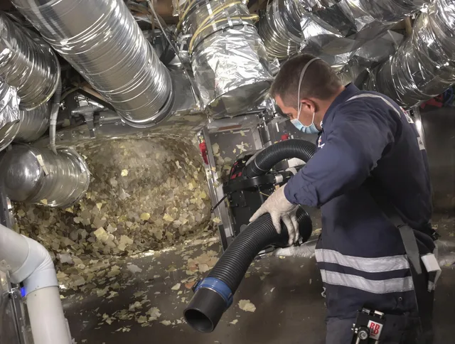 Holbrook Air Duct Cleaning specialist operating negative pressure cleaning equipment for thorough duct maintenance in Holbrook