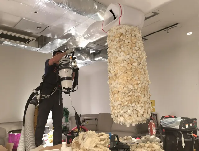Holbrook Air Duct Cleaning technician performing precision vacuum insulation removal in a residential property in Holbrook